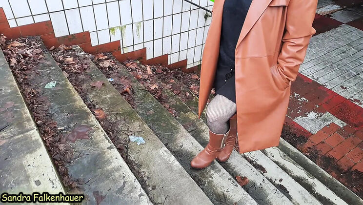 Sandra Falkenhauer takes a short outdoor walk in boots and fishnet stockings